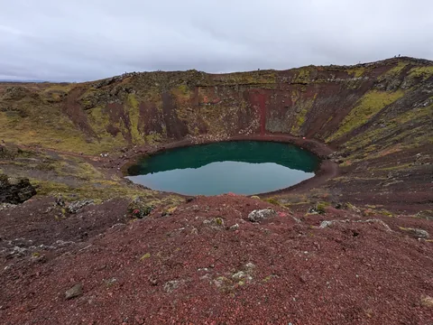 Red volcanic crater with a green lake at Kerið