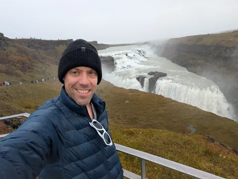 Nathan smiling in front of Gullfoss waterfall