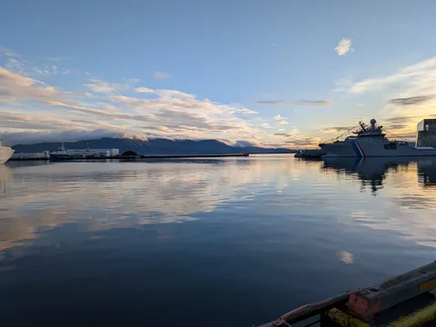 Reykjavík harbour at sunset with the coast guard ship and calm water